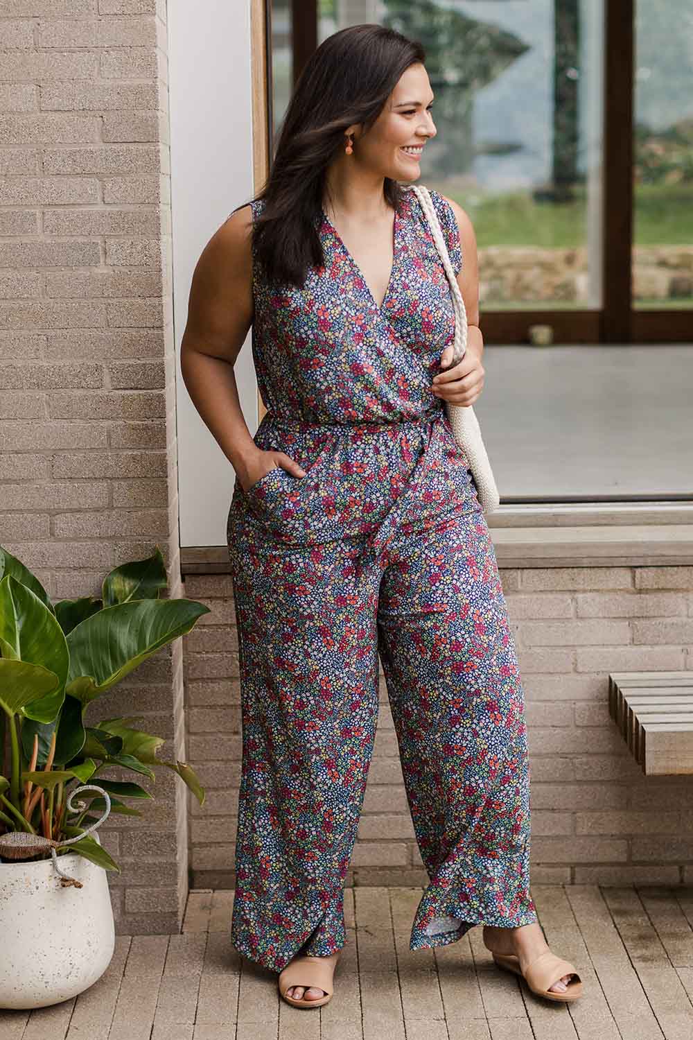Model Lauren wearing size 16 of the Belle Ditsy Floral Jumpsuit in colour Ditsyflora (Blue), from the front, showing the whole outfit