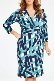 Model Laura wearing size 12 of the Belle Abstract Wrap Dress in colour Abstract (Green), from the front, cropped image