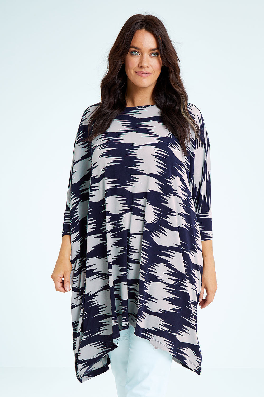 Model Laura wearing size M of the Belle Printed Throw Over in colour Strokes (Blue), from the front, cropped image
