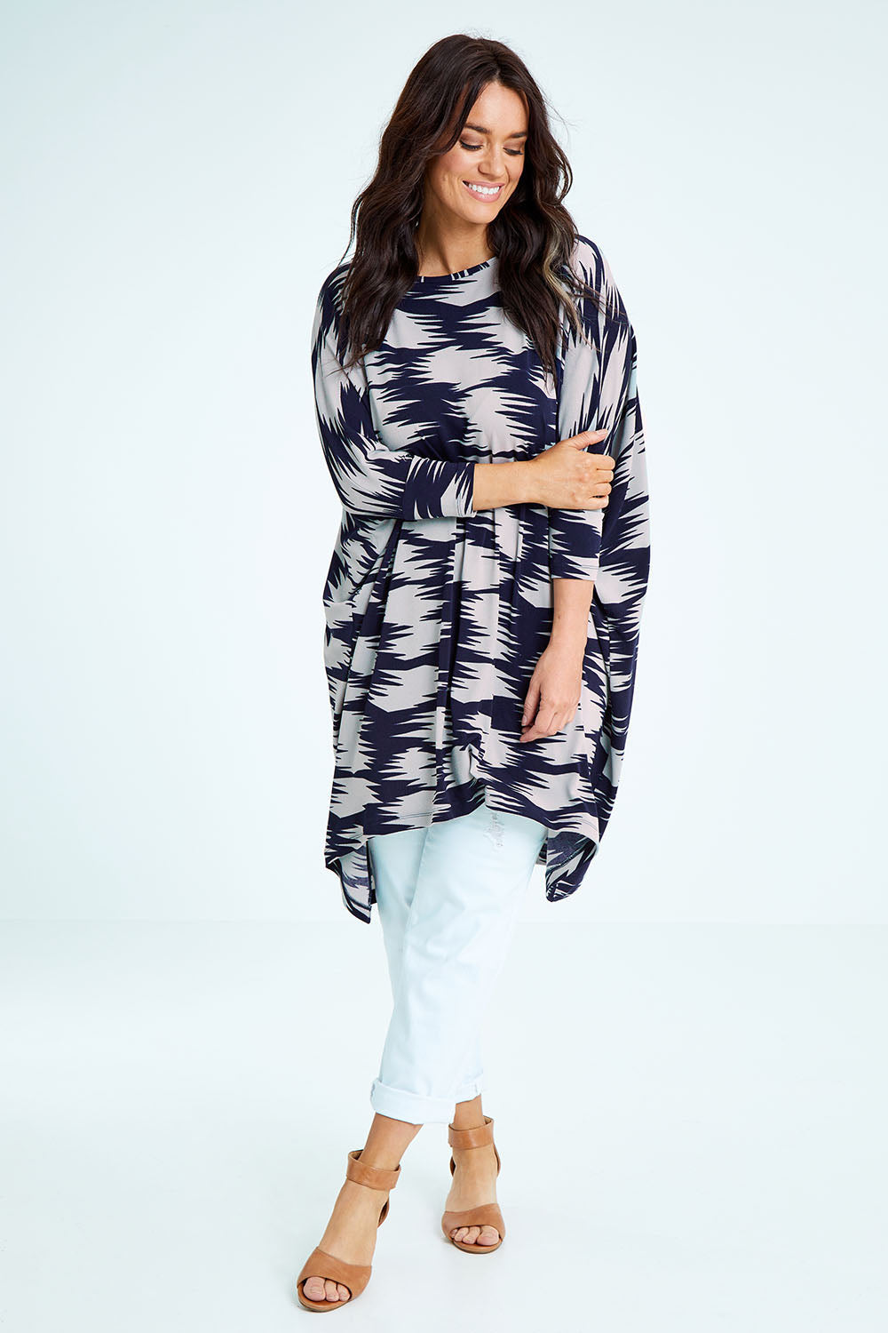 Model Laura wearing size M of the Belle Printed Throw Over in colour Strokes (Blue), from the front, showing the whole outfit