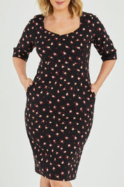 Model Jess wearing size 12 of the Belle Ditsy Floral Print Bengaline Dress in colour Ditsy (Black), from the front, cropped image