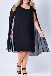Model Sophie wearing size 20 of the Belle Cape Dress in colour Black (Black), from the front, cropped image