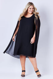 Model Sophie wearing size 20 of the Belle Cape Dress in colour Black (Black), from the front, showing the whole outfit