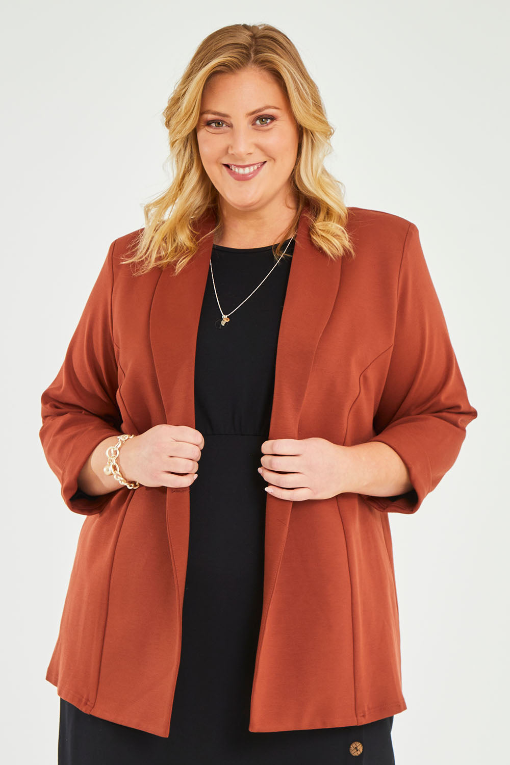 Model Caitlin wearing size 20 of the Belle Long Line Ponte Jacket in colour Ochre, from the front, cropped image