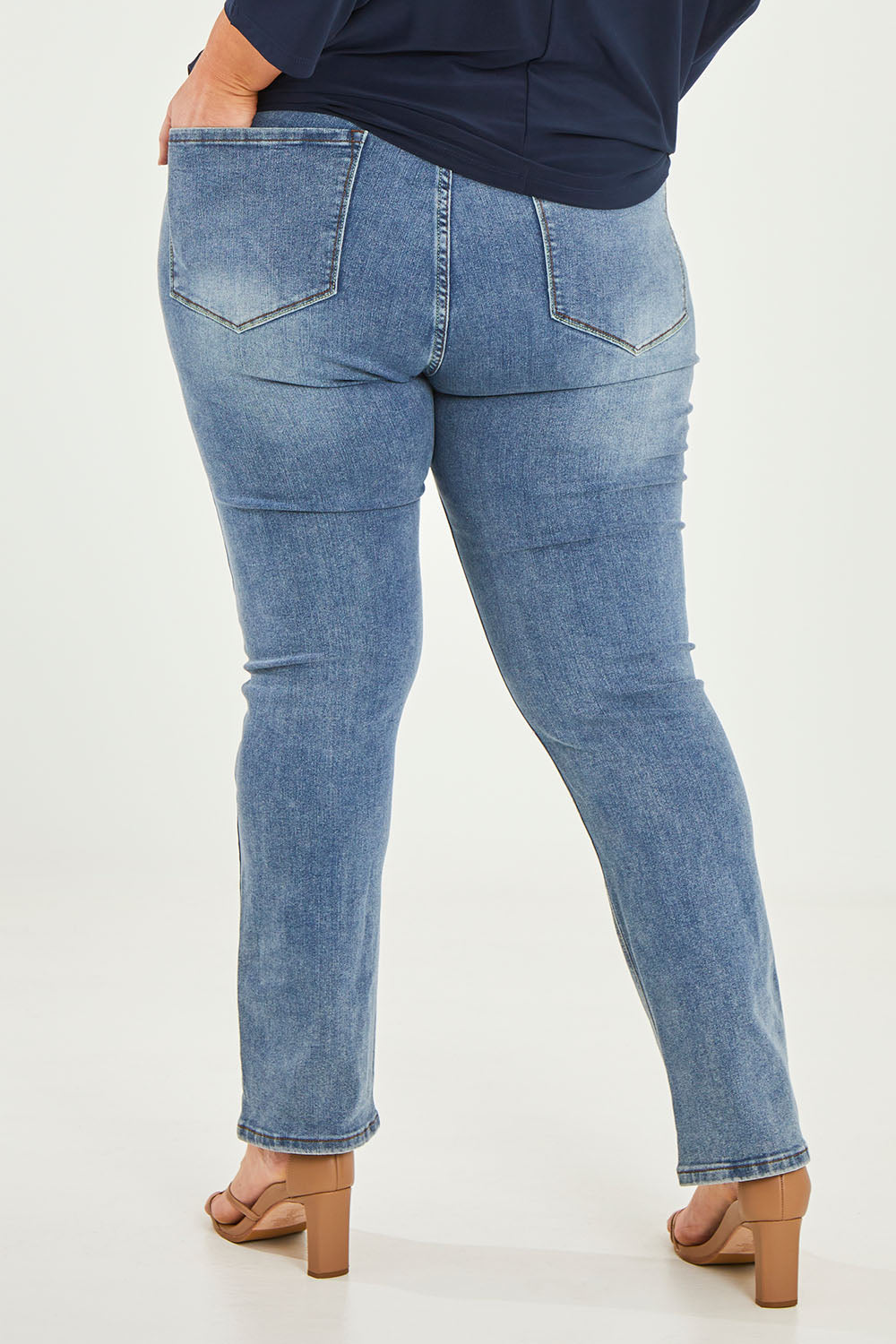 Model Caitlin wearing size 20 of the Belle Boot Leg Jean in colour Mediumblue (Blue), from the back