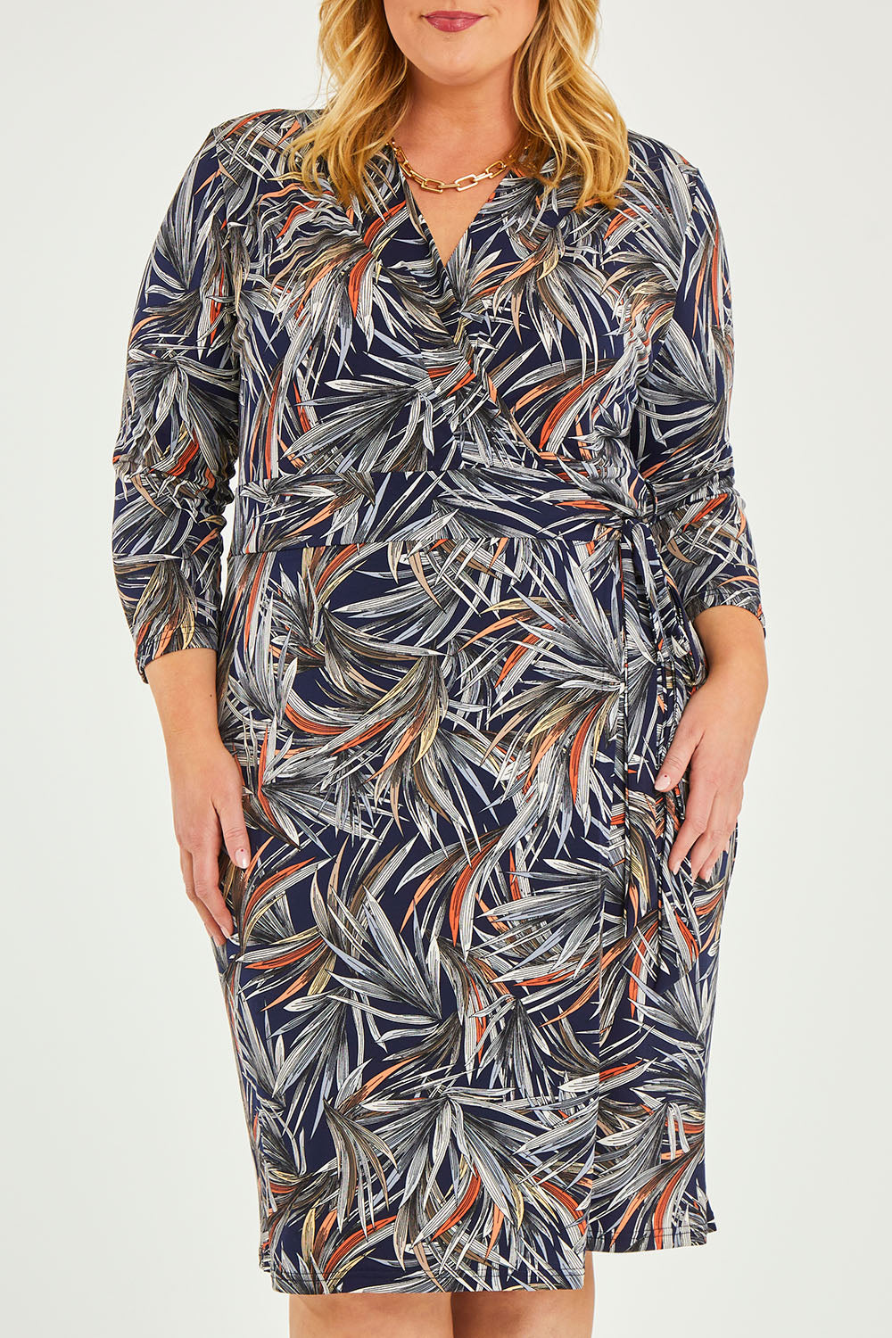 Model Caitlin wearing size 20 of the Belle Classic Lined Wrap Jersey Dress in colour Navyprint (Blue), from the front, cropped image