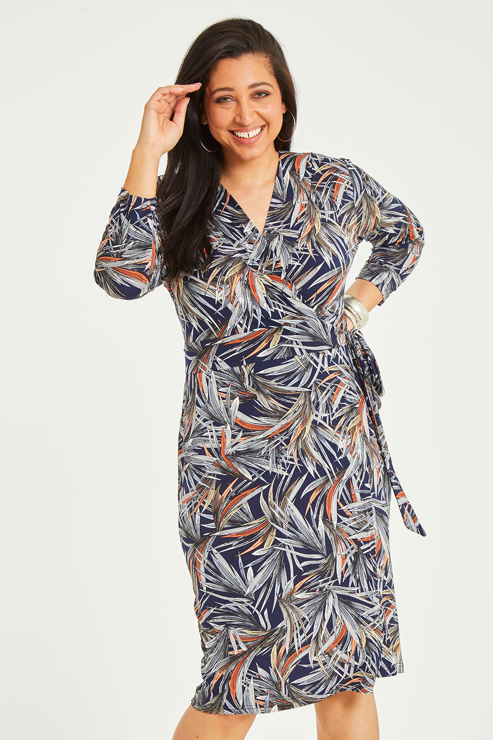 Model Terri-Leigh wearing size 14 of the Belle Classic Lined Wrap Jersey Dress in colour Navyprint (Blue), from the front, cropped image