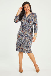 Model Terri-Leigh wearing size 14 of the Belle Classic Lined Wrap Jersey Dress in colour Navyprint (Blue), from the front, showing the whole outfit