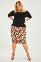 Model Caitlin wearing size 20 of the Belle Lined Side Gathered Skirt in colour Floral (White), from the front, showing the whole outfit