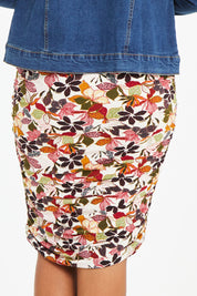Model Noli wearing size 14 of the Belle Lined Side Gathered Skirt in colour Floral (White), from the back