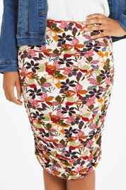 Model Noli wearing size 14 of the Belle Lined Side Gathered Skirt in colour Floral (White), from the front, cropped image