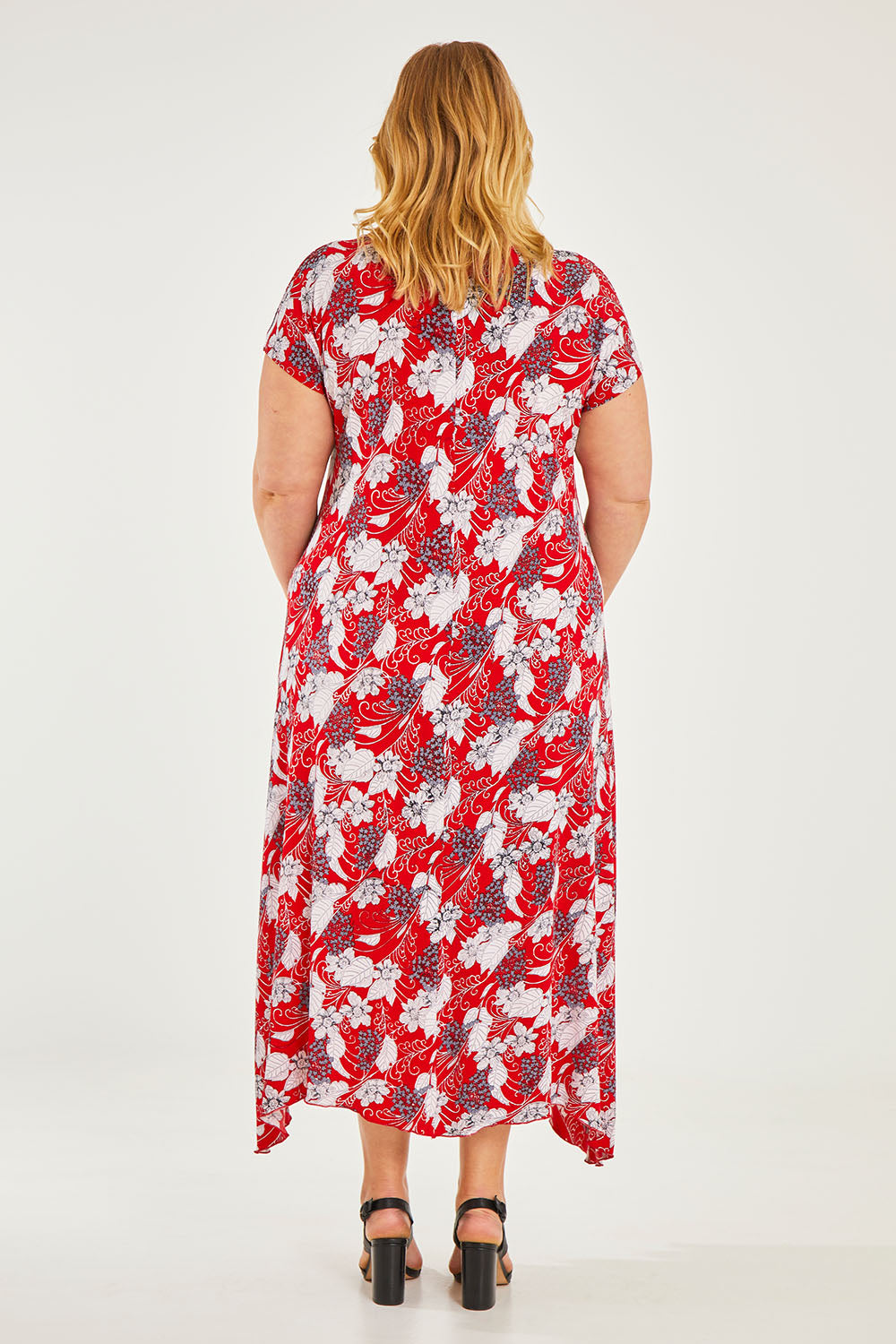 Model Caitlin wearing size 20 of the Belle High Low Dress With Pockets in colour Redfloral (Red), from the back