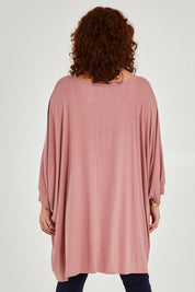 Model Maddy wearing size 16 of the Belle Goddess Cotton Tee in colour Blush (Pink), from the back