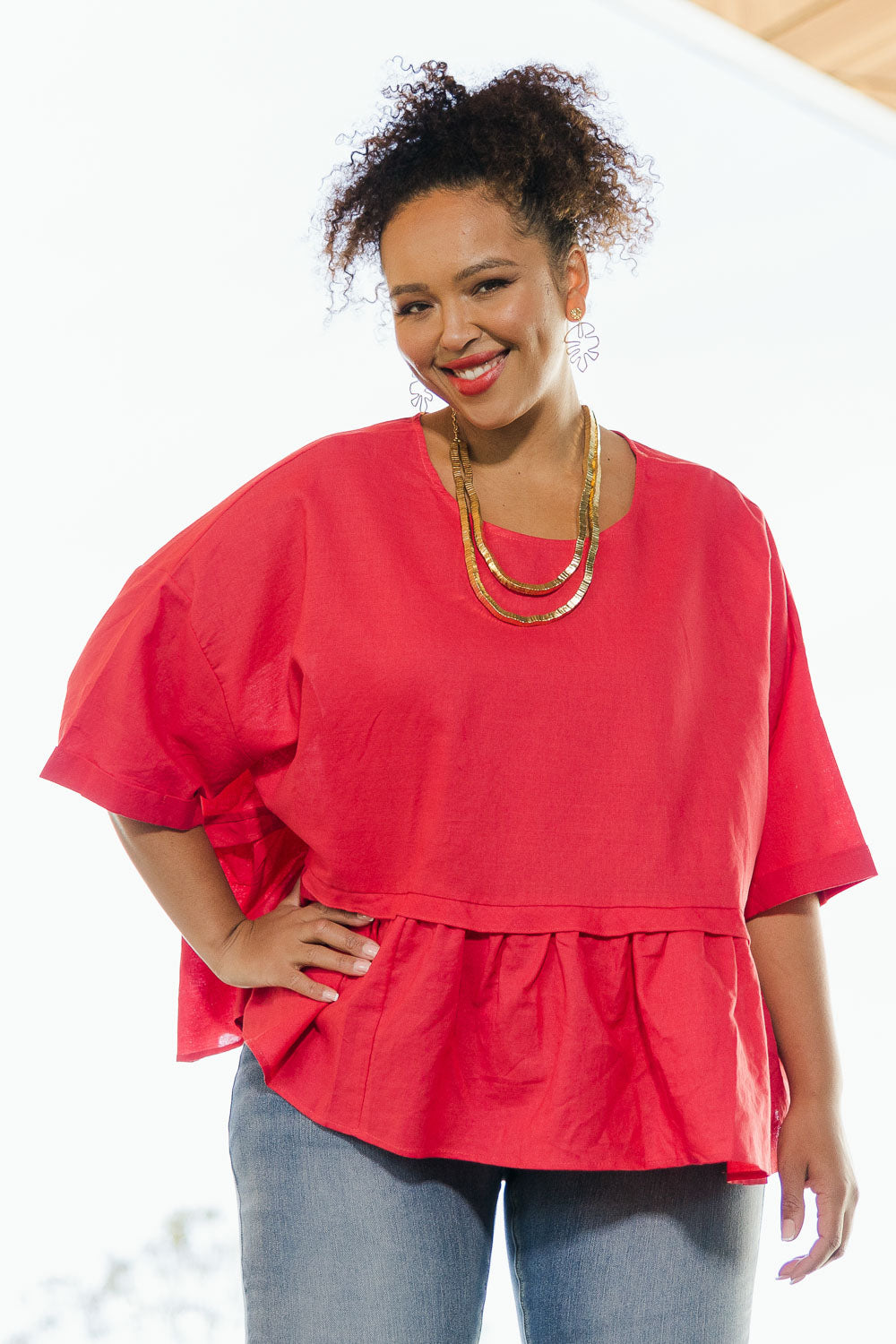 Model Alexis wearing size 18 of the Belle Layered Cotton Linen Kaftan Top in colour Lipstick (Red), from the front, showing the whole outfit