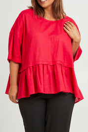 Model Monique wearing size 14 of the Belle Layered Cotton Linen Kaftan Top in colour Lipstick (Red), from the front, cropped image