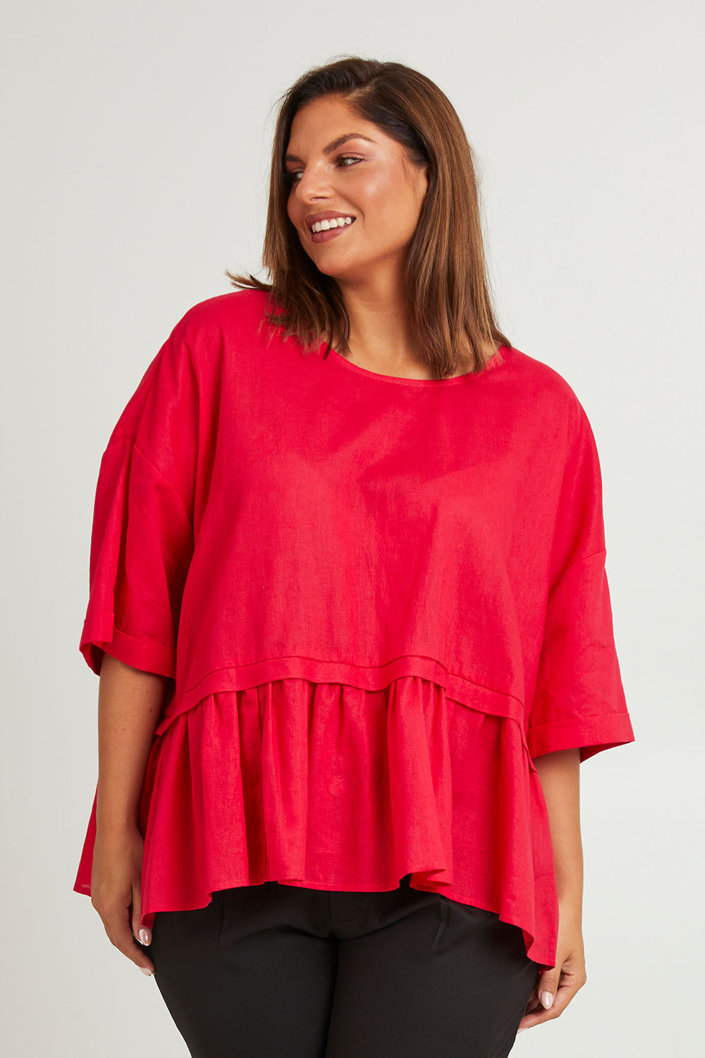 Model Monique wearing size 14 of the Belle Layered Cotton Linen Kaftan Top in colour Lipstick (Red), from the front, cropped image