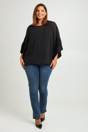 Model Monique wearing size 14 of the Belle Chiffon Bubble Detail Top w/Cami in colour Black (Black), from the front, showing the whole outfit