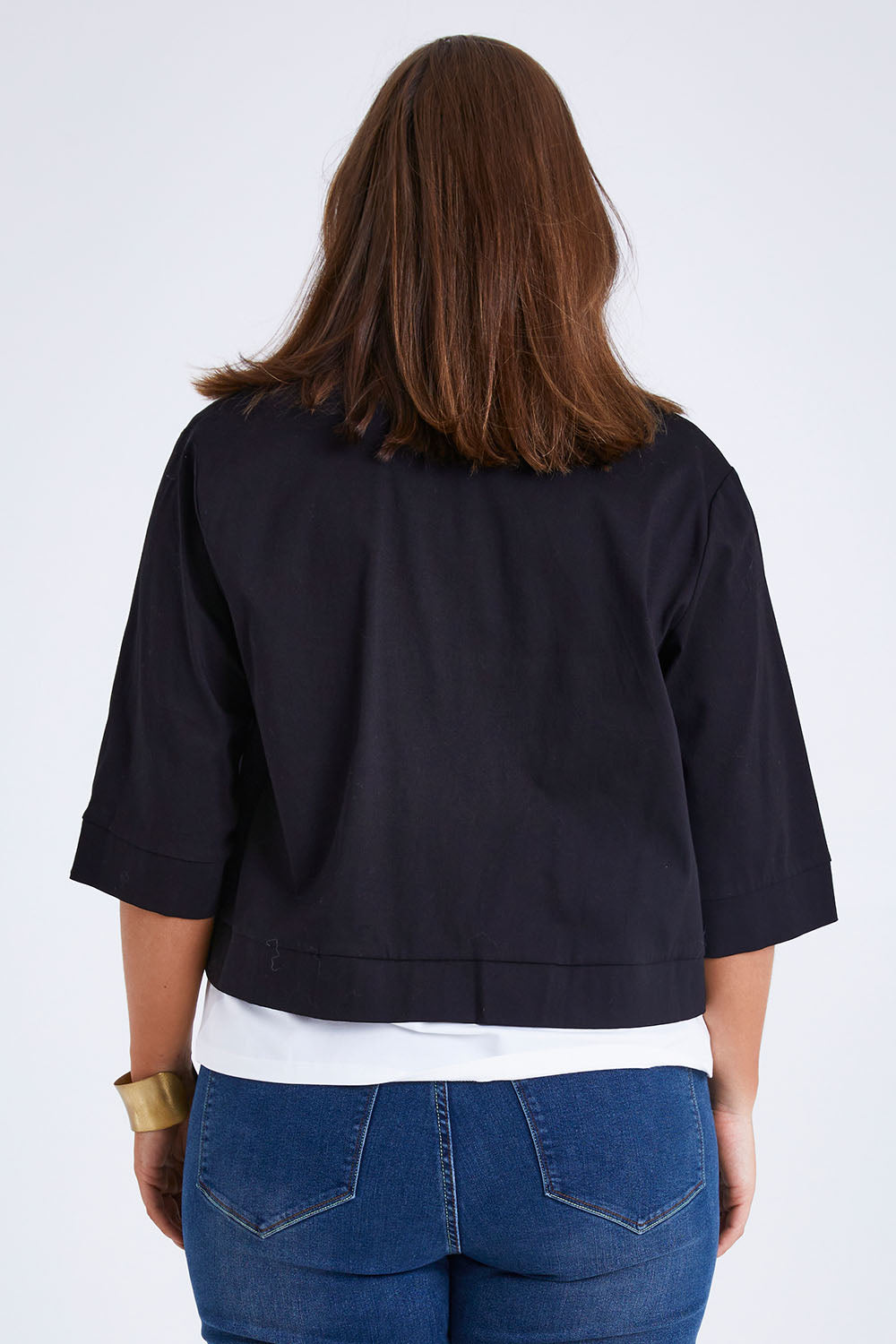 Model Monique wearing size 14 of the Belle Cotton Sateen Cropped Jacket in colour Black (Black), from the back