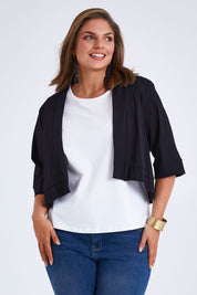 Model Monique wearing size 14 of the Belle Cotton Sateen Cropped Jacket in colour Black (Black), from the front, cropped image