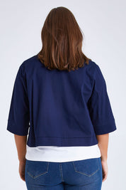 Model Monique wearing size 14 of the Belle Cotton Sateen Cropped Jacket in colour Navy (Blue), from the back