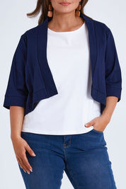 Model Monique wearing size 14 of the Belle Cotton Sateen Cropped Jacket in colour Navy (Blue), from the front, cropped image