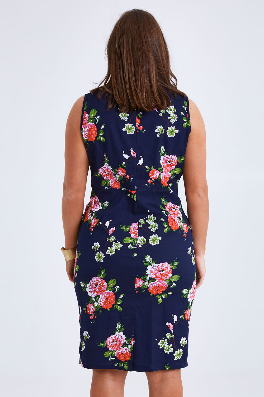 Model Monique wearing size 14 of the Belle V Neck Cotton Sateen Print  Dress in colour Bluefloral (Blue), from the back