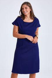 Model Monique wearing size 14 of the Belle A Line Cotton Sateen Dress in colour Sapphire (Blue), from the front, cropped image