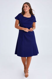 Model Monique wearing size 14 of the Belle A Line Cotton Sateen Dress in colour Sapphire (Blue), from the front, showing the whole outfit