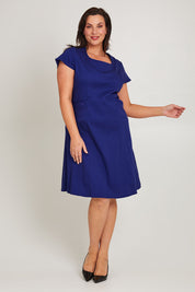 Model Poppy wearing size 16 of the Belle A Line Cotton Sateen Dress in colour Sapphire (Blue), from the front, showing the whole outfit