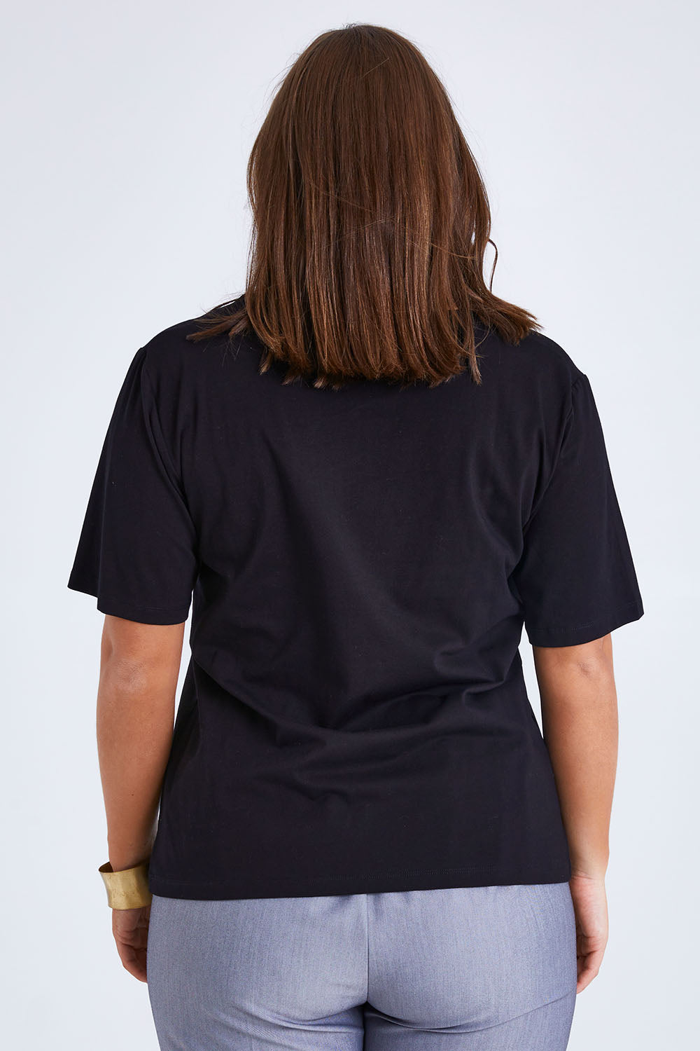 Model Monique wearing size 14 of the Belle Lace Insert Tee in colour Black (Black), from the back
