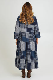 Model Laura wearing size 14 of the Its Easy Loving You Tiered Dress in colour Navypatch (Blue), from the back