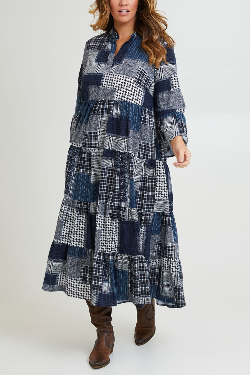 Model Laura wearing size 14 of the Its Easy Loving You Tiered Dress in colour Navypatch (Blue), from the front, cropped image