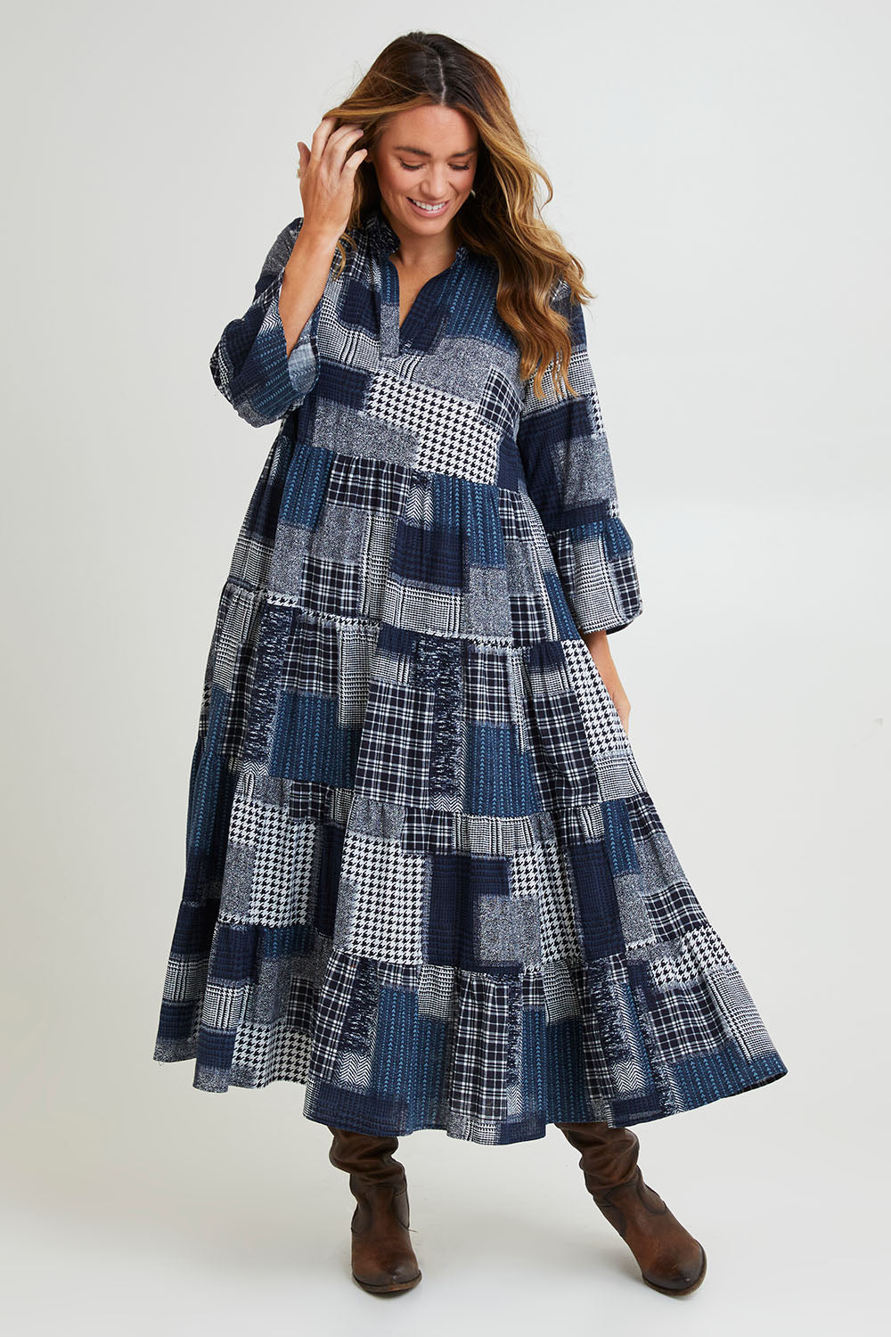 Model Laura wearing size 14 of the Its Easy Loving You Tiered Dress in colour Navypatch (Blue), from the front, showing the whole outfit