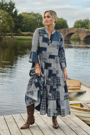 Model Tegan wearing size 10 of the Its Easy Loving You Tiered Dress in colour Navypatch (Blue), from the front, showing the whole outfit