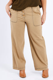 Model Laura wearing size 14 of the Chill Out Calling Jeans in colour Moss, from the front, cropped image