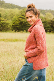 Model Ilona wearing size S of the Soft Cloud Roll Neck Jumper in colour Brick (Red), from the front, showing the whole outfit