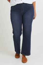 Model Laura wearing size 14 of the Easy As Pull On Jeans in colour Darkdenim (Blue), from the front, cropped image
