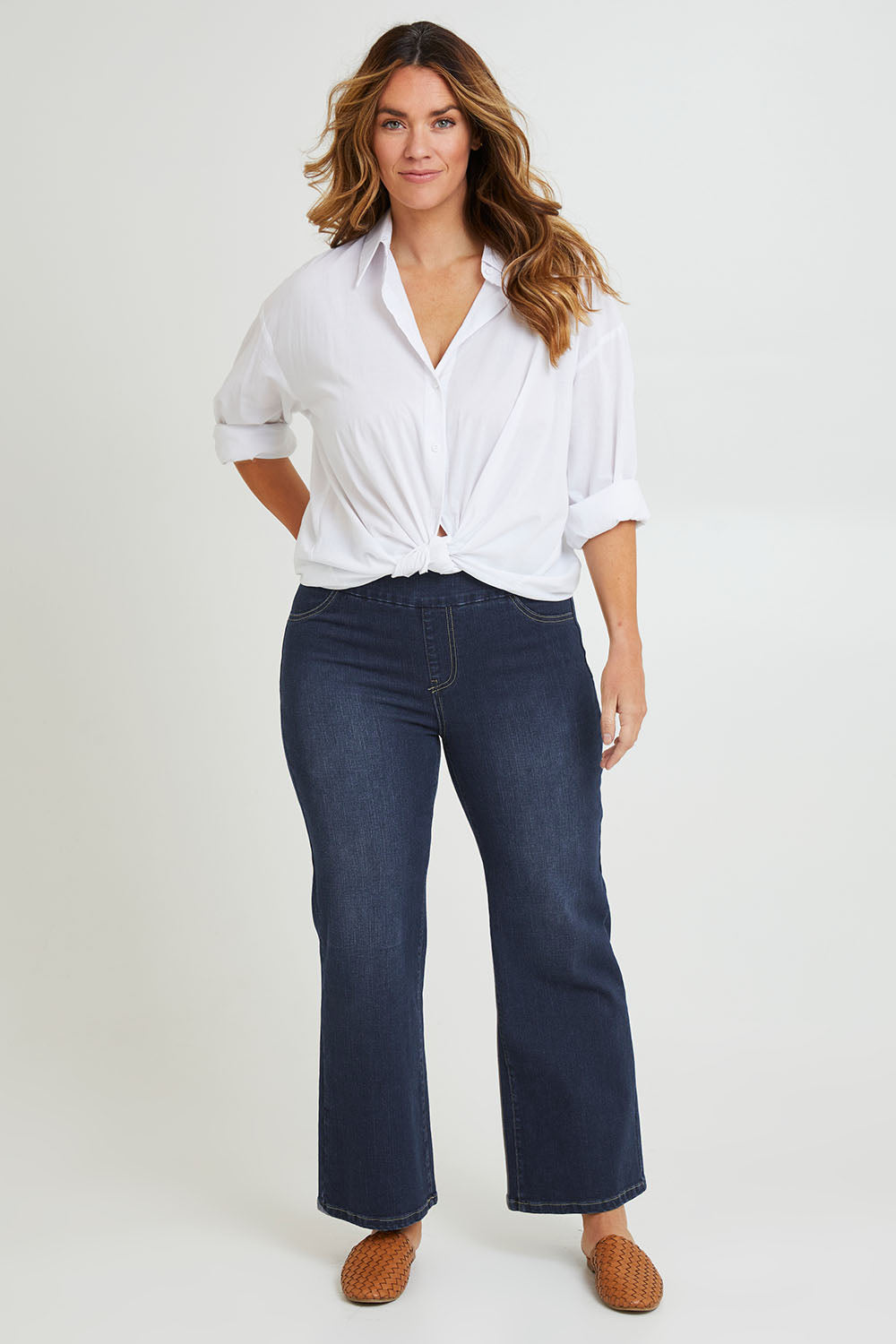 Model Laura wearing size 14 of the Easy As Pull On Jeans in colour Darkdenim (Blue), from the front, showing the whole outfit