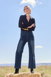 Model Tegan wearing size 10 of the Easy As Pull On Jeans in colour Darkdenim (Blue), from the front, showing the whole outfit