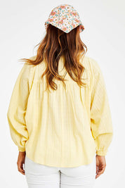 Model Laura wearing size 14 of the Easy Like A Sunday Morning Blouse in colour Buttermilk, from the back