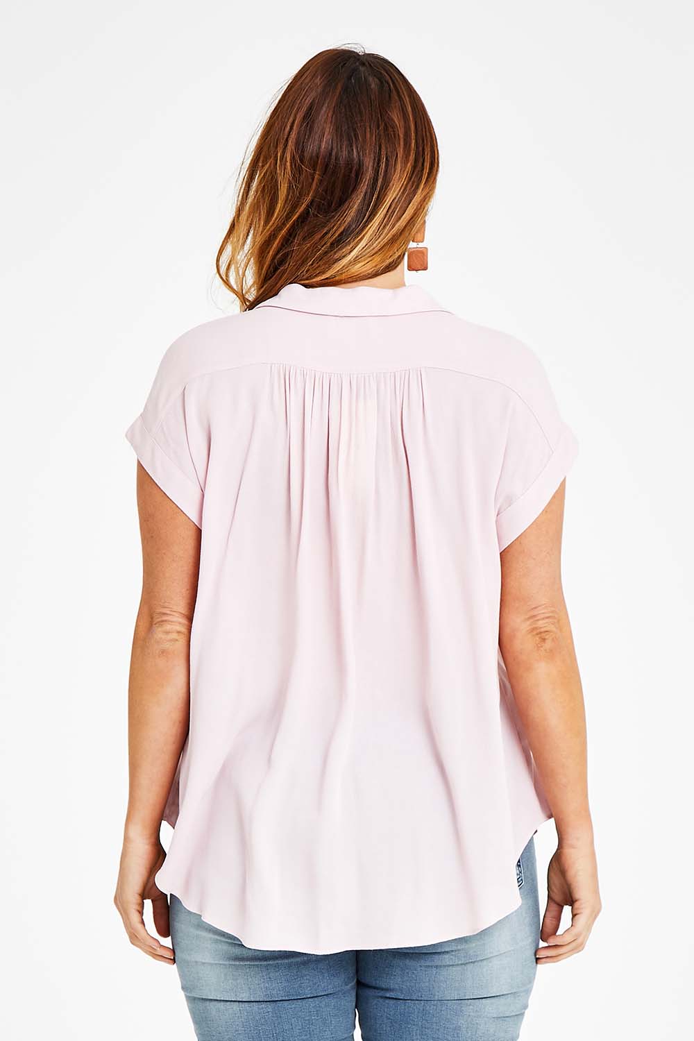 Model Laura wearing size 14 of the Go Your Own Way Button Blouse in colour Blush (Pink), from the back