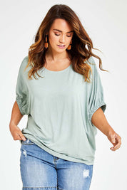 Model Laura wearing size 14 of the In My Arms Tee in colour Sage (Green), from the front, cropped image