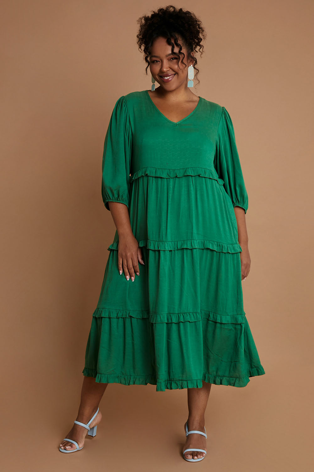 Model Alexis wearing the Tiers Of Laughter Maxi Dress in colour Emerald (Green), from the front, showing the whole outfit