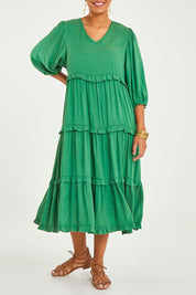 Model Noli wearing size 14 of the Tiers Of Laughter Maxi Dress in colour Emerald (Green), from the front, cropped image