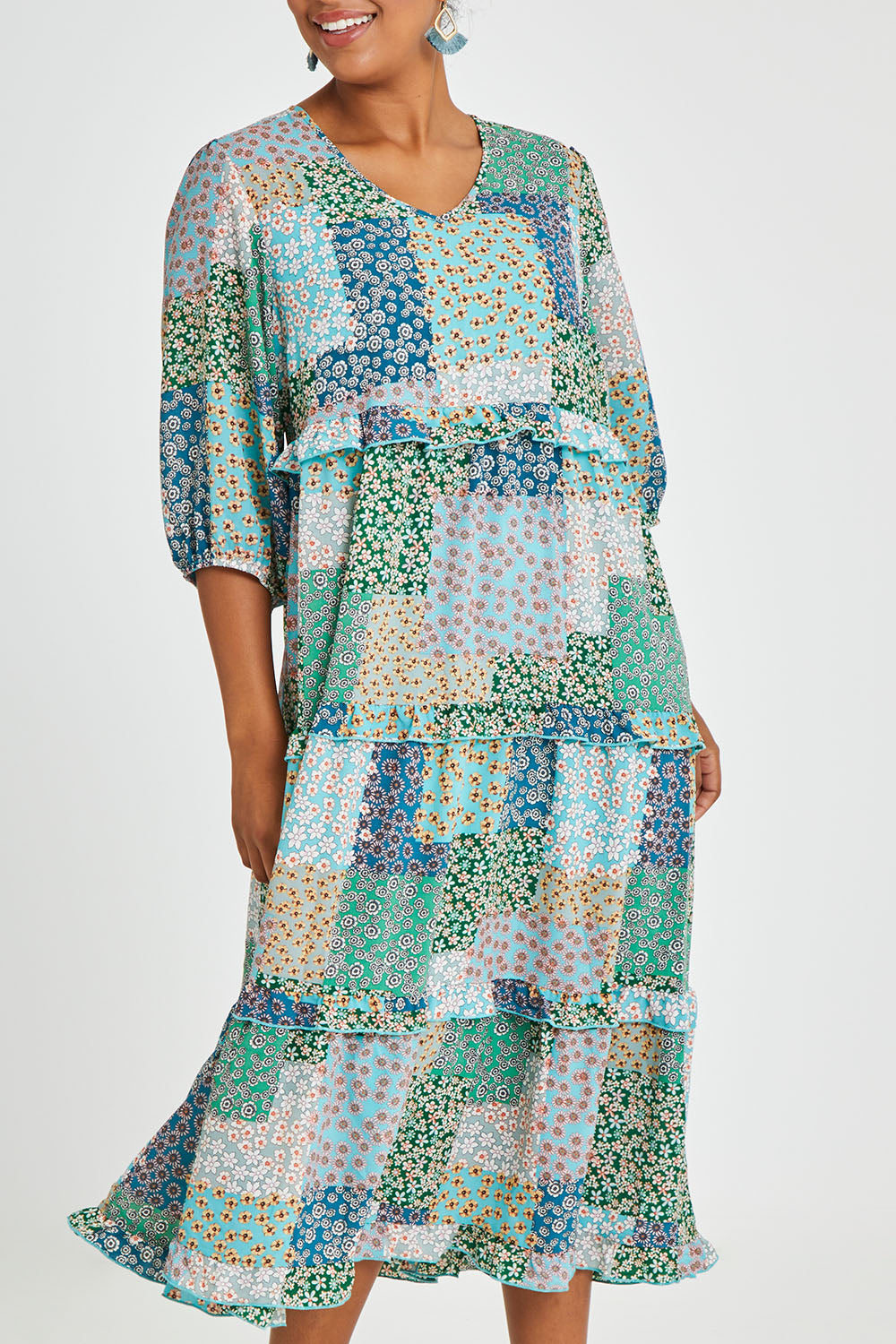 Model Noli wearing size 14 of the Tiers Of Laughter Maxi Dress in colour Bluepatch (Blue), from the front, cropped image