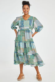 Model Noli wearing size 14 of the Tiers Of Laughter Maxi Dress in colour Bluepatch (Blue), from the front, showing the whole outfit