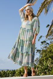 Model Tegan wearing size 10 of the Tiers Of Laughter Maxi Dress in colour Bluepatch (Blue), from the front, showing the whole outfit