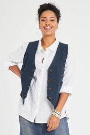 Model Noli wearing size 14 of the Preloved Fine and Dandy Denim Vest in colour Darkdenim (Blue), from the front, cropped image