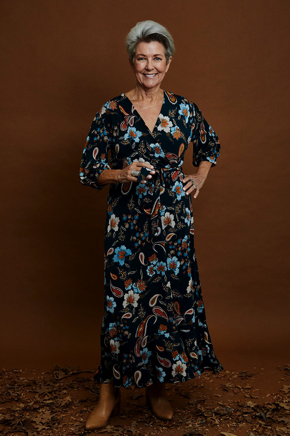 Model Elise wearing size 10 of the Feeling Free Faux Wrap Dress in colour Greenbay (Green), from the front, showing the whole outfit