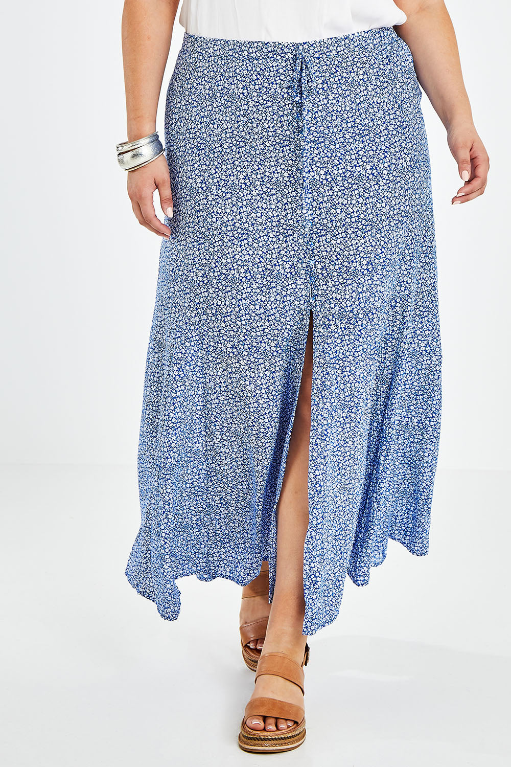 Model Jess wearing size 14 of the Nothing But Blue Skies Skirt in colour Bluefleur (Blue), from the front, cropped image